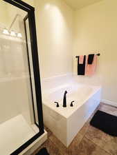 Bathroom featuring tile patterned floors and a tub to relax in