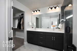 Primary bathroom featuring vanity and an enclosed shower