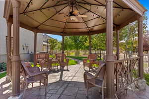 View of patio with a gazebo and ceiling fan