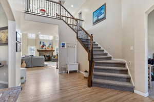 Staircase featuring hardwood / wood-style floors and a high ceiling