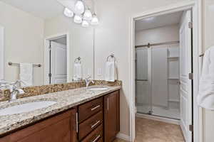 Bathroom featuring vanity and an enclosed shower