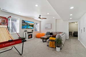 Carpeted living room with ceiling fan