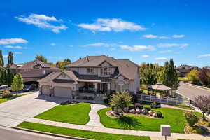 View of front facade with a garage and a front lawn