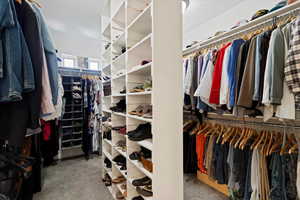 Spacious closet featuring carpet flooring