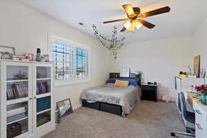 Carpeted bedroom with ceiling fan