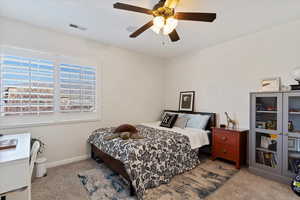 Bedroom featuring ceiling fan and light carpet