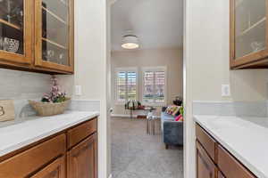 Bar with carpet and tasteful backsplash