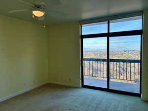 Carpeted spare room with ceiling fan