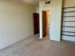 Unfurnished bedroom featuring light colored carpet