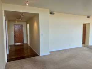 Corridor with carpet floors and track lighting