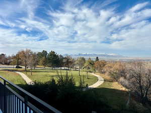 View of property's community featuring a lawn and a mountain view