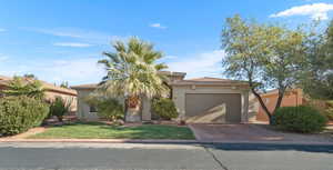 View of front of property with a front lawn and a garage