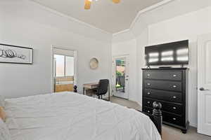 Bedroom with ceiling fan, access to exterior, light colored carpet, and connected bathroom