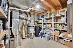 Utility room featuring secured water heater