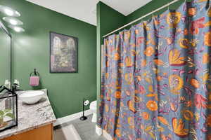 Bathroom featuring toilet, vanity, and tile patterned floors