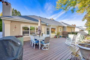 Wooden terrace featuring grilling area