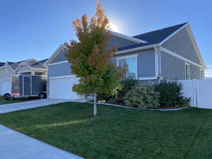 View of front of home featuring a garage and a front lawn