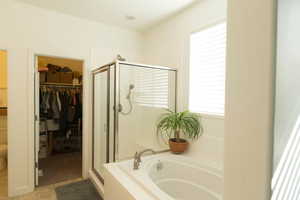 Bathroom with tile patterned flooring, plus walk in shower, and toilet