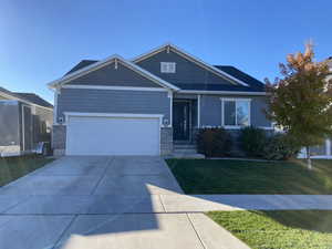 Craftsman-style home with a garage and a front lawn