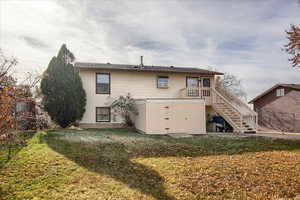 Rear view of property featuring a lawn