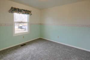 Unfurnished room with carpet