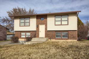 Raised ranch with a front yard