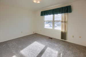 Unfurnished room featuring carpet flooring