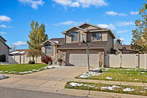 Front facade with a garage and a front lawn