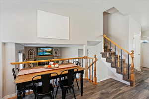 Dining space with dark wood-type flooring