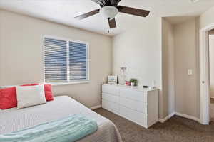 Bedroom featuring ceiling fan and carpet floors