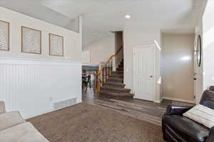 Living room featuring dark hardwood / wood-style flooring and vaulted ceiling