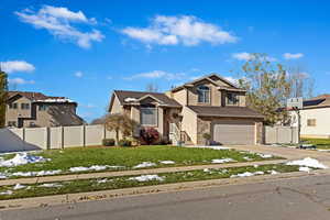 View of front of home featuring a garage and a front yard