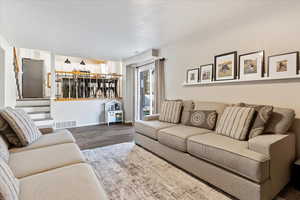 Living room with dark wood-type flooring