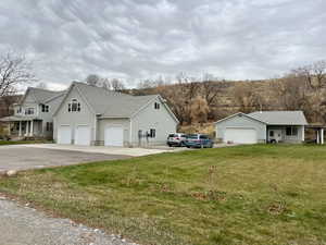 View of home's exterior featuring a garage and a lawn