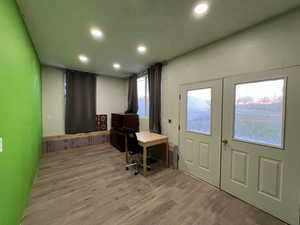 Entrance foyer featuring wood-type flooring, a textured ceiling, and french doors