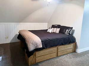 Carpeted bedroom with vaulted ceiling