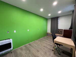 Office area featuring heating unit and light hardwood / wood-style flooring