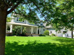 View of front facade featuring a porch and a front yard