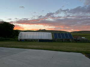 beautiful mountains and sunsets. greenhouses and solar panels