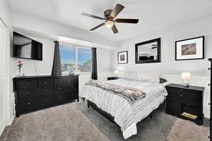 Carpeted bedroom with ceiling fan