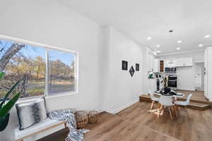 Dining room with light hardwood / wood-style flooring and an inviting chandelier