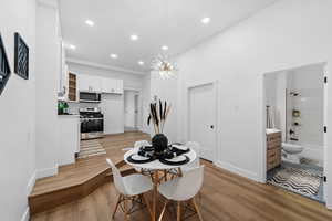 Dining space with a chandelier and light hardwood / wood-style floors