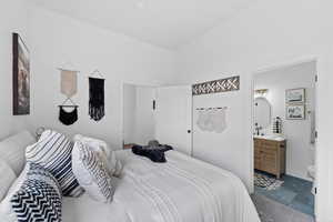 Bedroom with carpet, ensuite bath, and sink