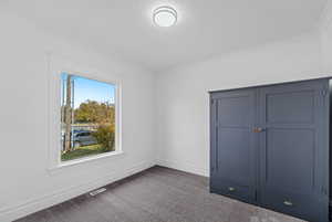 Unfurnished bedroom with carpet and ornamental molding