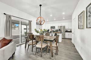 Dining area with wood-type flooring and a chandelier