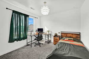 Carpeted bedroom with a notable chandelier and a textured ceiling