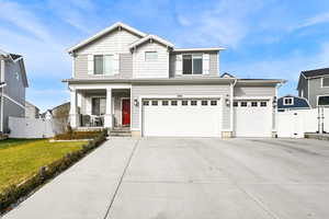 View of front of home featuring a front yard and a garage