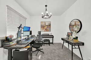 Office featuring carpet and an inviting chandelier