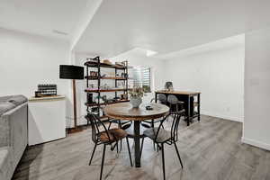 Dining area with light hardwood / wood-style flooring