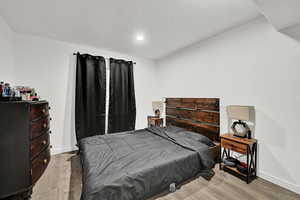 Bedroom with light hardwood / wood-style floors